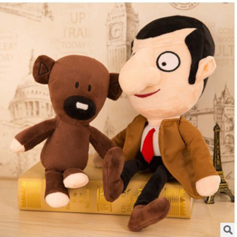 Mr Bean teddy bear and plush toy sitting together on a book, capturing the fun and charm of the classic character.